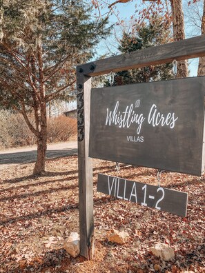 Whistling Acres sign on property.