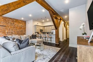 Open-concept living, kitchen, dining area with ample seating for you and your guests. 65” Samsung Smart 4K TV with streaming and DIRECTV Entertainment. The sofa converts to a queen-size sleeper! Dining table seats four. Plenty of natural light!