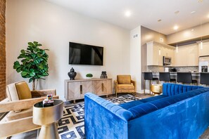Open-concept living, kitchen, dining area with ample seating for you and your guests. 65” Samsung Smart 4K TV with streaming and DIRECTV Entertainment. The sofa converts to a queen-size sleeper! Dining table seats four. Plenty of natural light!