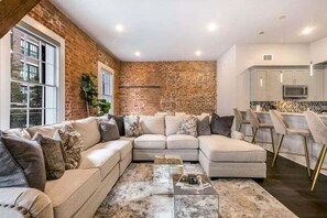 Open-concept living, kitchen, dining area with ample seating for you and your guests. 65” Samsung Smart 4K TV with streaming and DIRECTV Entertainment. The sofa converts to a queen-size sleeper! Dining table seats four. Plenty of natural light!