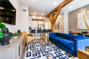 Open-concept living, kitchen, dining area with ample seating for you and your guests. 65” Samsung Smart 4K TV with streaming and DIRECTV Entertainment. The sofa converts to a queen-size sleeper! Dining table seats four. Plenty of natural light!