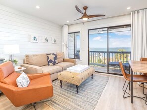 Living area with sleeper sofa and Smart TV, and attached balcony