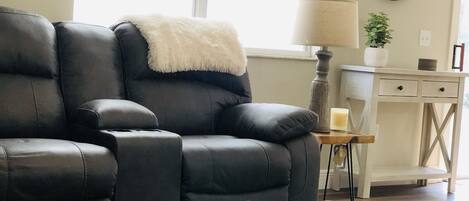 Living room with reclining sofa and reclining love seat. 