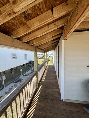 Covered walkway up the stairs on the side of the house