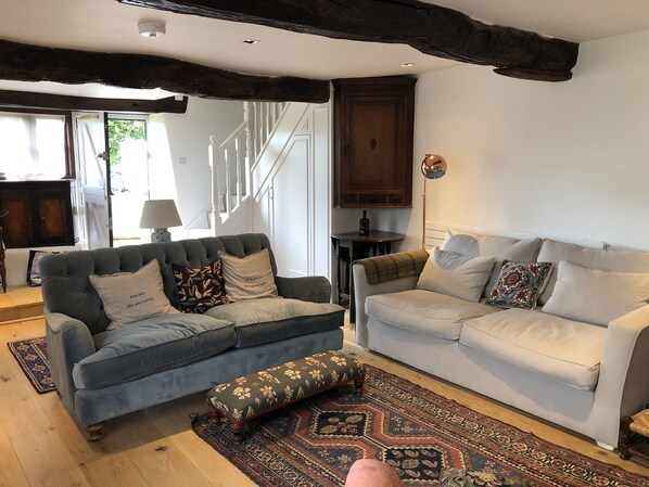 lounge room with wood burning stove and 2 large sofas