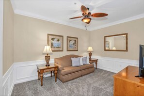 Classy living area of the condo in Orlando Florida - Cozy seating area conducive to relaxation and socializing - Well-chosen lighting fixtures adding both functionality and charm - Smart TV for entertainment