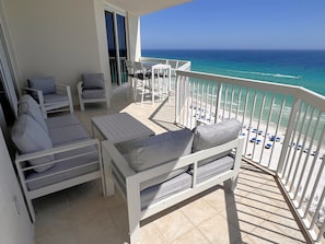 Large ocean front balcony with sofa &  loveseat!  Balcony seating for all ten!