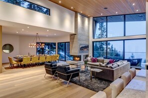 Spacious and inviting main living space with gorgeous views, luxury furniture, wood-burning fireplace, smart TV