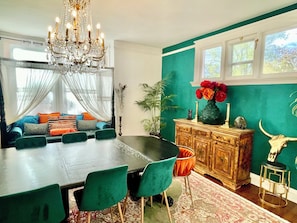 Big light dining room with antique dining table that can accommodate 12 people