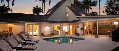 Dusk by the pool, outdoor bar and covered terrace