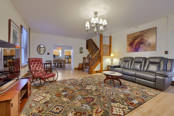 Beautiful furnishings featuring a reclining leather sofa and large screen TV