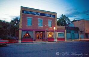 The room is the former storefront to the right of the hotel.
