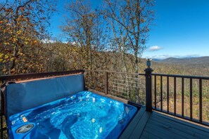 Luxurious hot tub on the deck overlooking the mountains.