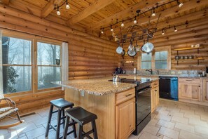 Kitchen with a dishwasher, island seating, and 2 types of coffeemakers (Drip-style & Keurig).