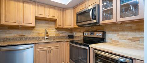 Updated Kitchen With Stainless Steel Appliances and Wine Refrigerator