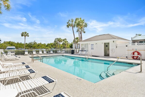 The pool offers a refreshing oasis, perfect for relaxing or swimming while enjoying the sunny weather.