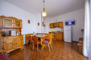 The living room with dinner table and view of the kitchen