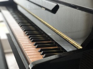 sit down for a serenade at the mini grand piano...