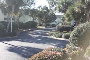 walk through parking lot to bridge over lake to south pool and beach