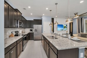 Enter the spacious, fully equipped kitchen, where culinary creativity knows no bounds.