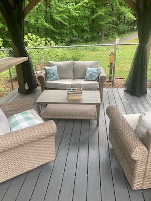 Love seat and swivel chairs under the pool pergola