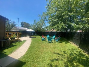 A fire pit, patio table + chairs and gas grill make this the perfect hangout!