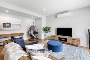 The sunny, upstairs open plan living area has Blackbutt hardwood timber floors and split system heating-cooling.