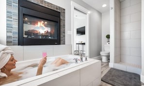 Soak in this fabulous master bathroom tub with gas a  fireplace 