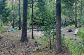 View of the stream, firepit, and hammock from the cabin deck!