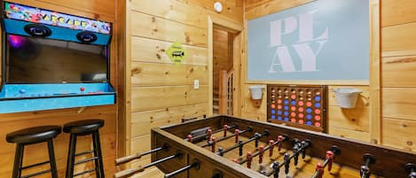 Game room with arcade, foosball, and giant connect four