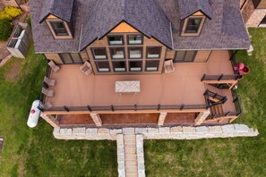 Upper deck, outdoor table and propane gas grill.