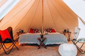 A look inside one of our Twin tents which includes 2 twin beds. Note: furniture, décor and bed configuration may differ between tents.