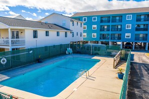 The community pool with outdoor shower.