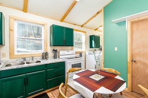 Fully-stocked kitchen with dishwasher, stove/oven, and microwave.