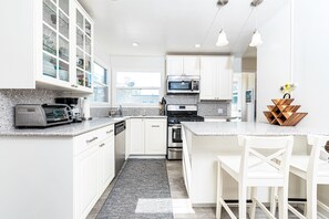 The bar area with bar stools is a perfect additional seating area so the house chef can cook with an audience!
                