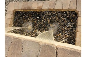 Waterfall fountain in front of home.