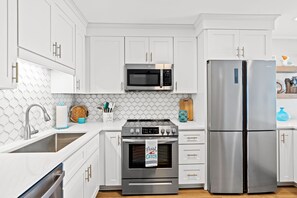 Fridge has 3 cool sections and a small freezer in the bottom left compartment.