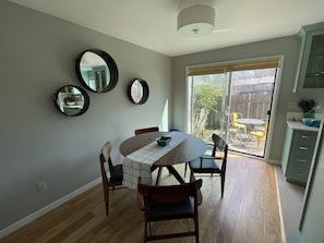 Dining area off kitchen.  Access to back patio with table and chairs.  