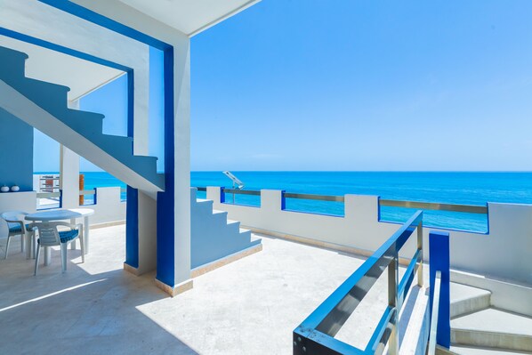 Second floor oceanfront patio, two lounge chairs have been added