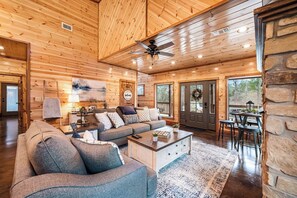 Nice size living room with a pub table and a smart TV 