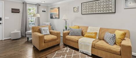Spacious living room extends a wide sofa & accent chairs