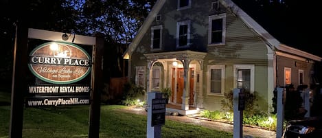 Evening picture of the front entrance to the Curry House, lighted brick pathway!