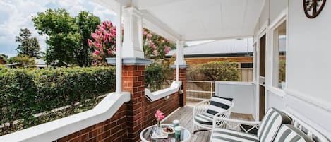 The front patio is set with outdoor seating overlooking a quiet street.