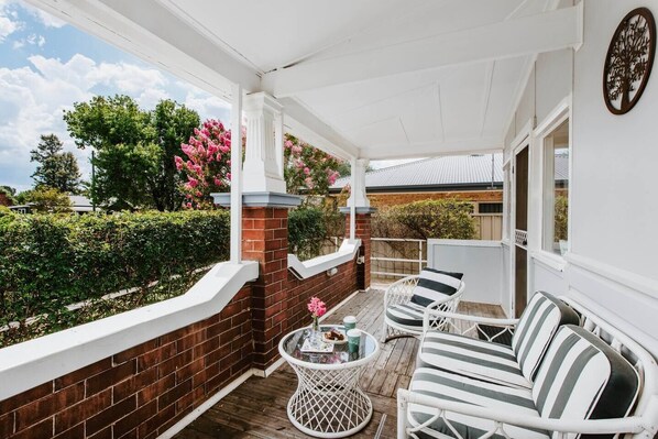 The front patio is set with outdoor seating overlooking a quiet street.