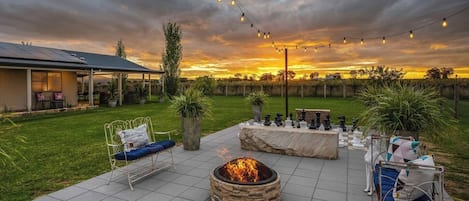 Gather around the fire pit for evening cocktails and roasted marshmallows come evening, strewn with festoon lights.