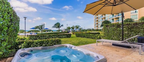 Patio w/ lounge chair, umbrella, and a private hot tub