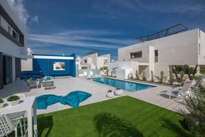Garden with barbecue, seating area, sun loungers and private pool