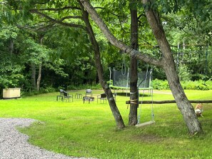 Backyard fire pit and trampoline
