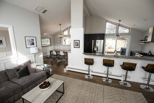 Looking from the living into the open kitchen and dining area.