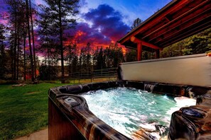Enjoy the top of the line hot tub  view at sunset after a day of adventuring outdoors.